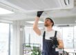 Male Technician Repairing Air Conditioner