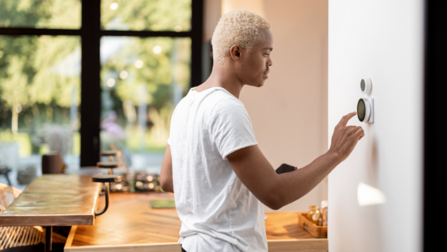 Person adjusting thermostat